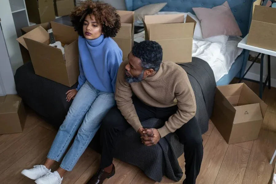 A couple preparing for a move with packed boxes